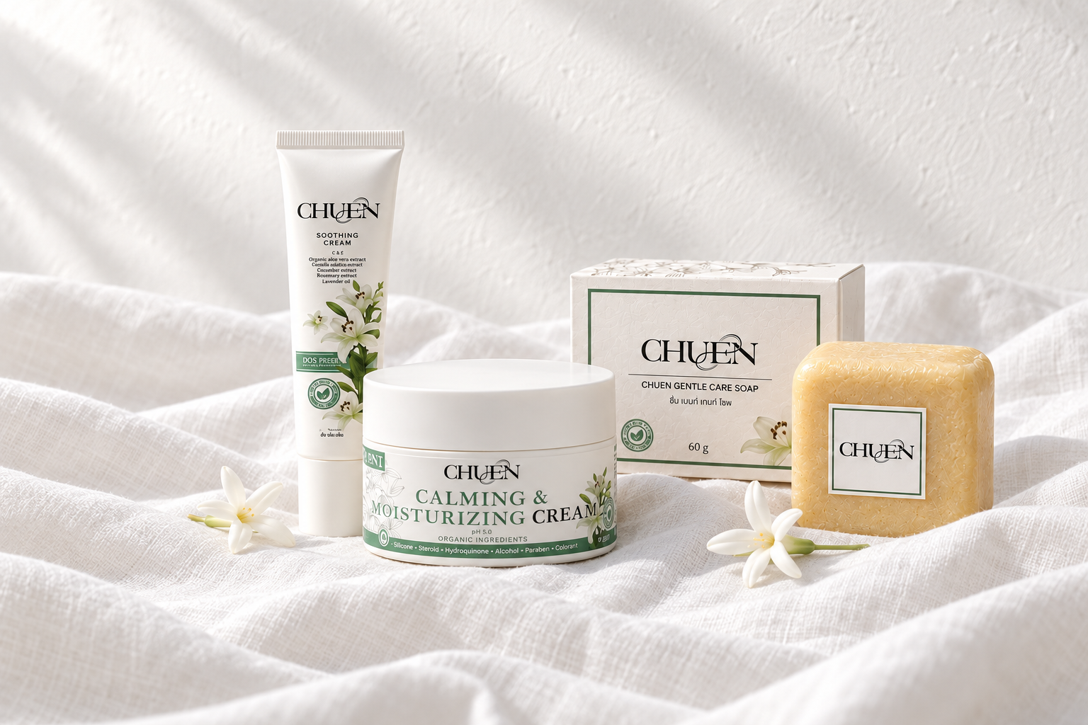The CHUEN collection on textured white linen with two dok peeb flowers